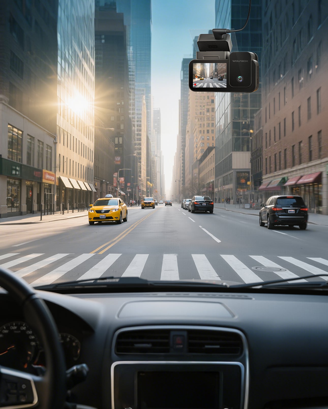 City street scene with a car dashboard view, including a yellow taxi and tall buildings.